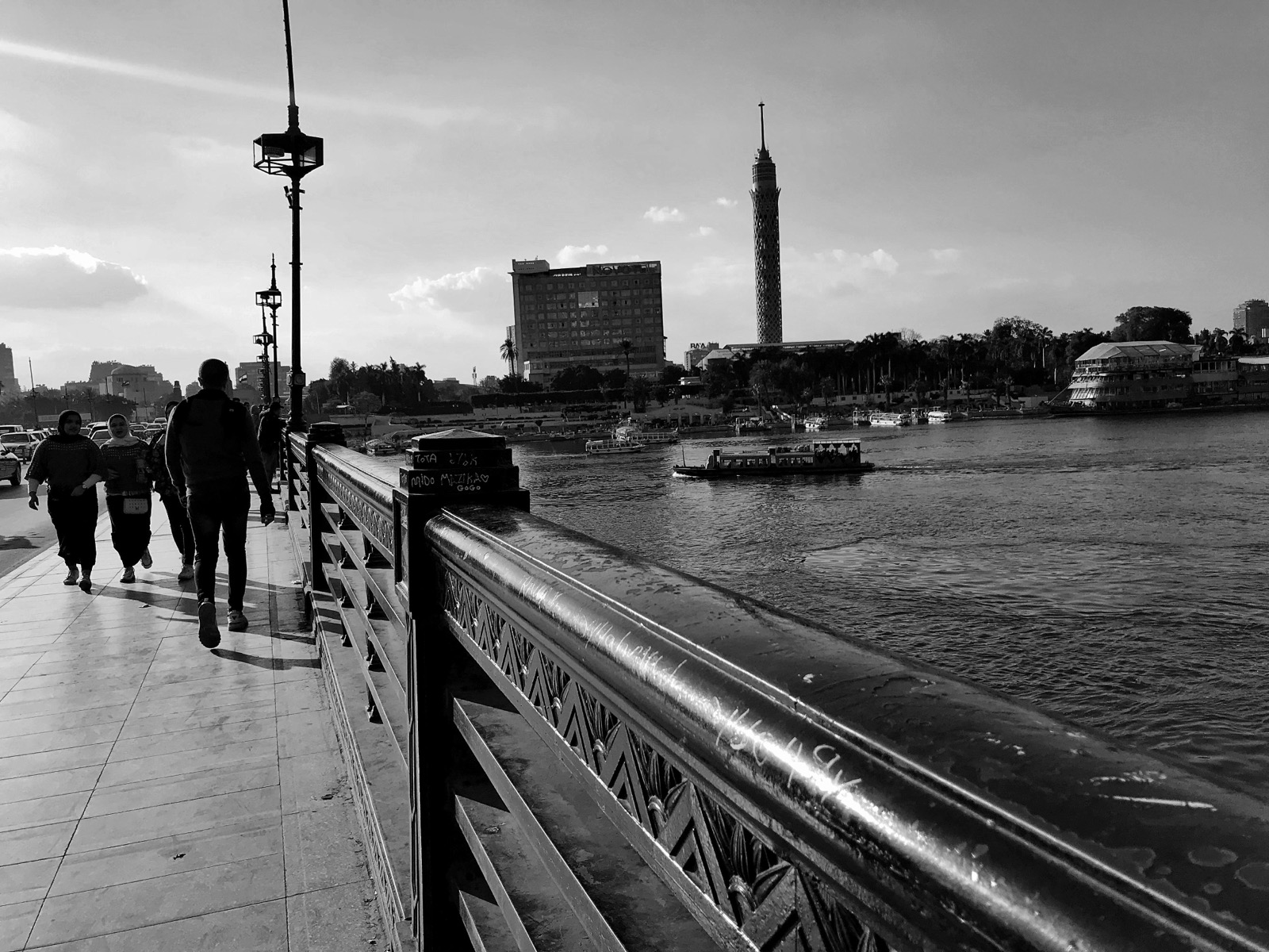 Crossing a Nile bridge with the Cairo Tower in view